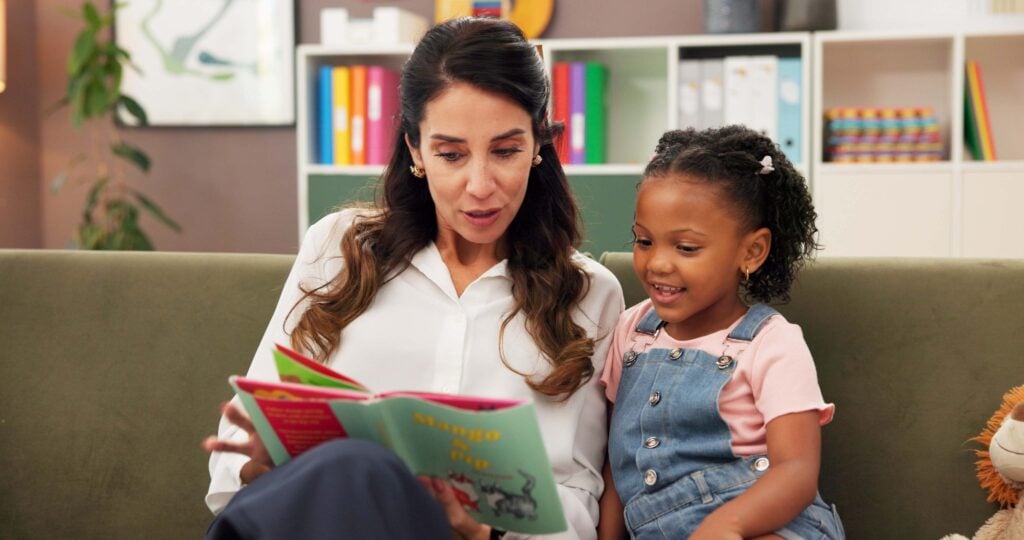 Psychologist, child and reading story in office for speech therapy, mental health and learning. Therapist woman, book and girl for evaluation, clinic or consultation for patient development support